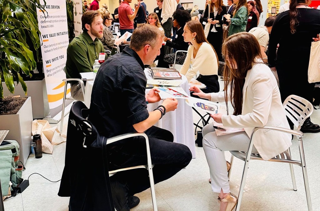 An employer and a prospectie student employee sit down during a hiring event to talk. 